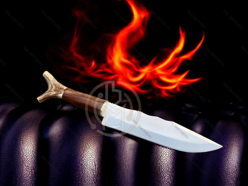 May include: A handcrafted knife with a wooden handle and a polished blade. The handle features a unique antler design. The knife is set against a dark background with a fiery orange and red graphic, creating a dramatic effect.