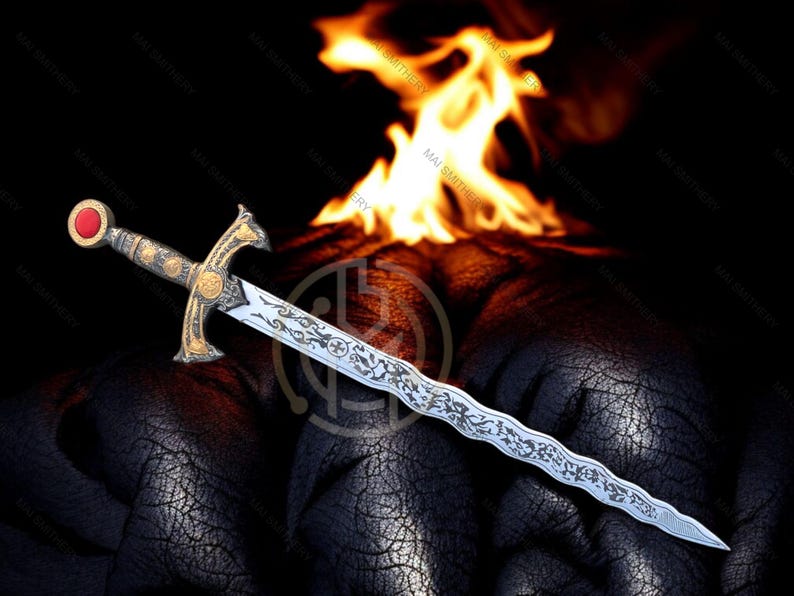 May include: An ornate sword with a silver blade and gold hilt, featuring intricate engravings. The hilt has a red gem at the pommel. Flames are in the background, set against a dark, textured surface. A decorative item.