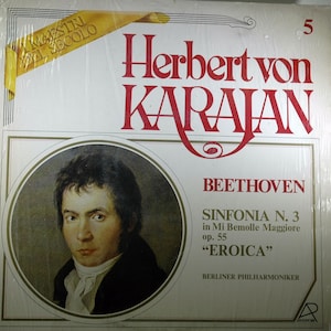 May include: A vintage vinyl record album cover featuring a portrait of Ludwig van Beethoven, the composer of the symphony "Eroica". The cover is white with red and gold lettering. The title reads "Herbert von Karajan Beethoven Sinfonia N. 3 in Mi Bemolle Maggiore op. 55 "Eroica" Berliner Philharmoniker".