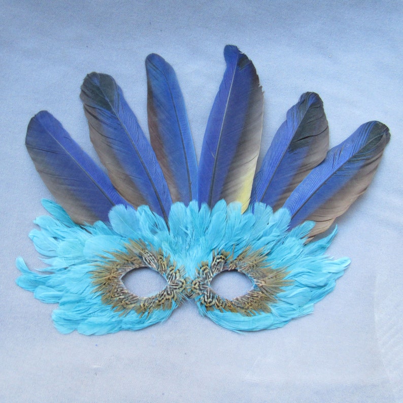 Turquoise Feather Mask Crowned by Macaw Feathers to become a fantasy character at a party or parade