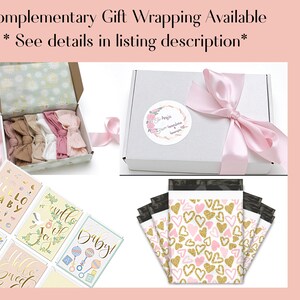 May include: An assortment of baby-themed items, including headbands, greeting cards, and packaging. The headbands are in a variety of neutral colors and are displayed in an open box. The cards have gold foil accents and the text "Hello Baby".