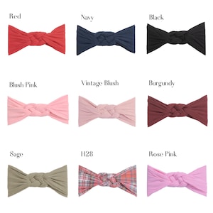 May include: Nine headbands in various colors, including red, navy, black, blush pink, vintage blush, burgundy, sage, plaid, and rose pink. Each headband features a braided knot design.