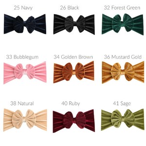 May include: Nine velvet headbands in various colors, including navy, black, forest green, bubblegum pink, golden brown, mustard gold, natural, ruby, and sage. Each headband features a large, knotted bow.
