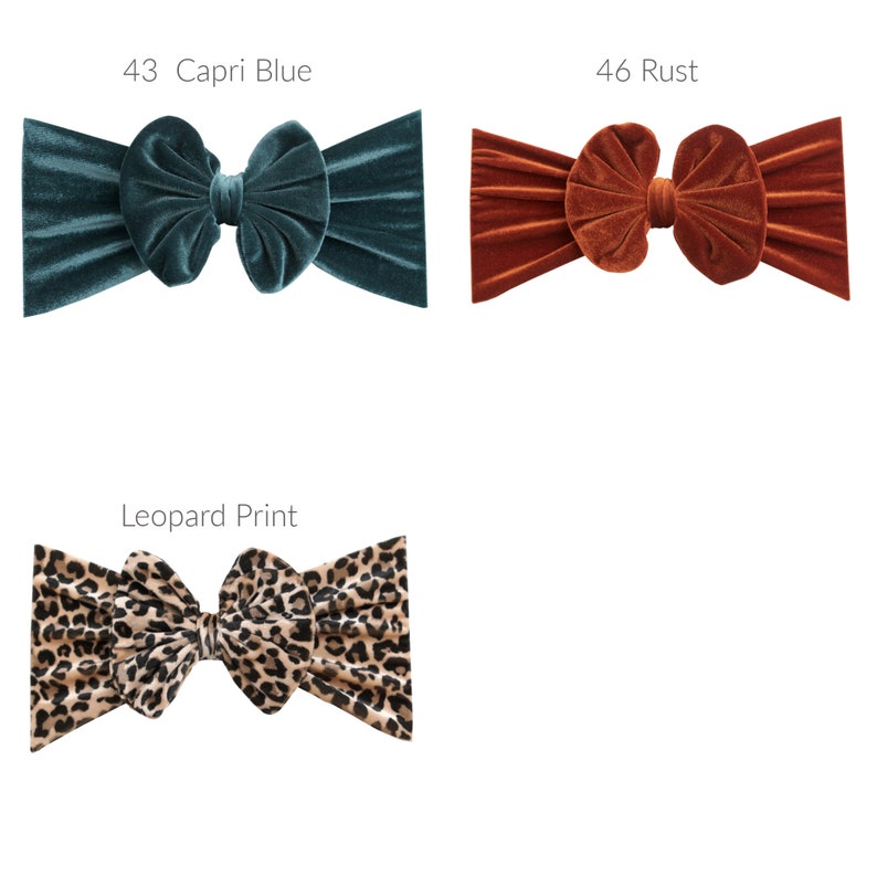 May include: Three velvet headbands in different colors and patterns. The first headband is teal blue, the second is rust orange, and the third is a leopard print.
