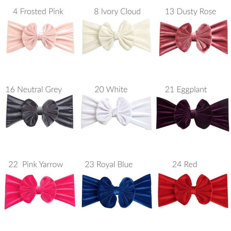 May include: Nine velvet headbands in various colors, including frosted pink, ivory cloud, dusty rose, neutral grey, white, eggplant, pink yarrow, royal blue, and red. Each headband features a large, knotted bow.