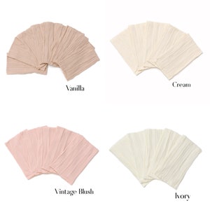 May include: Four sets of fabric swatches in different colors: vanilla, cream, vintage blush, and ivory. Each set is arranged in a fan shape.