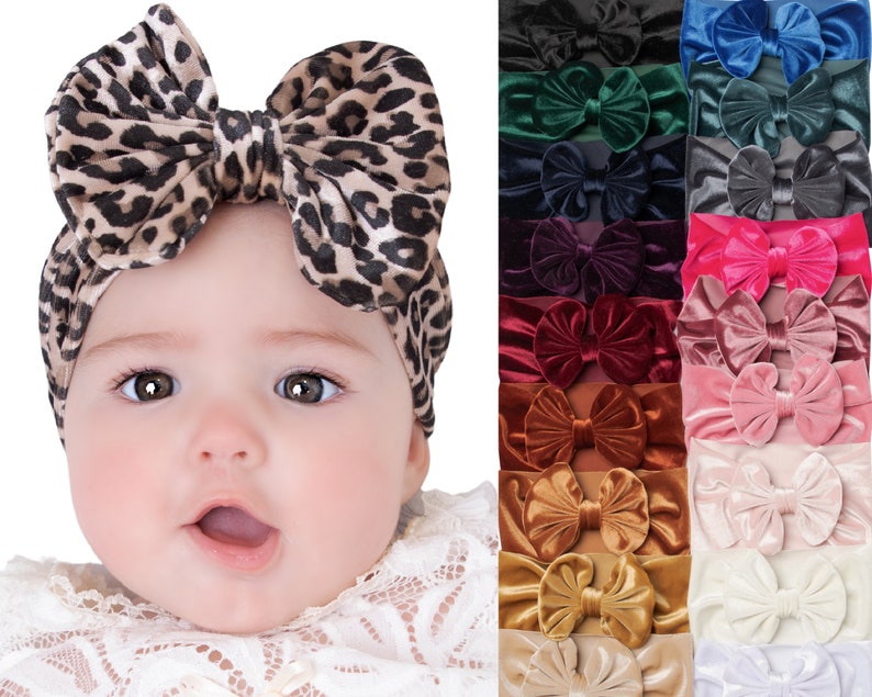 May include: A set of 18 velvet hair bows in various colors, including black, blue, green, red, pink, brown, gold, and white. The bows are arranged in two rows of nine, with each bow featuring a double bow design. The bows are made of soft, stretchy velvet and are perfect for adding a touch of elegance to any outfit.