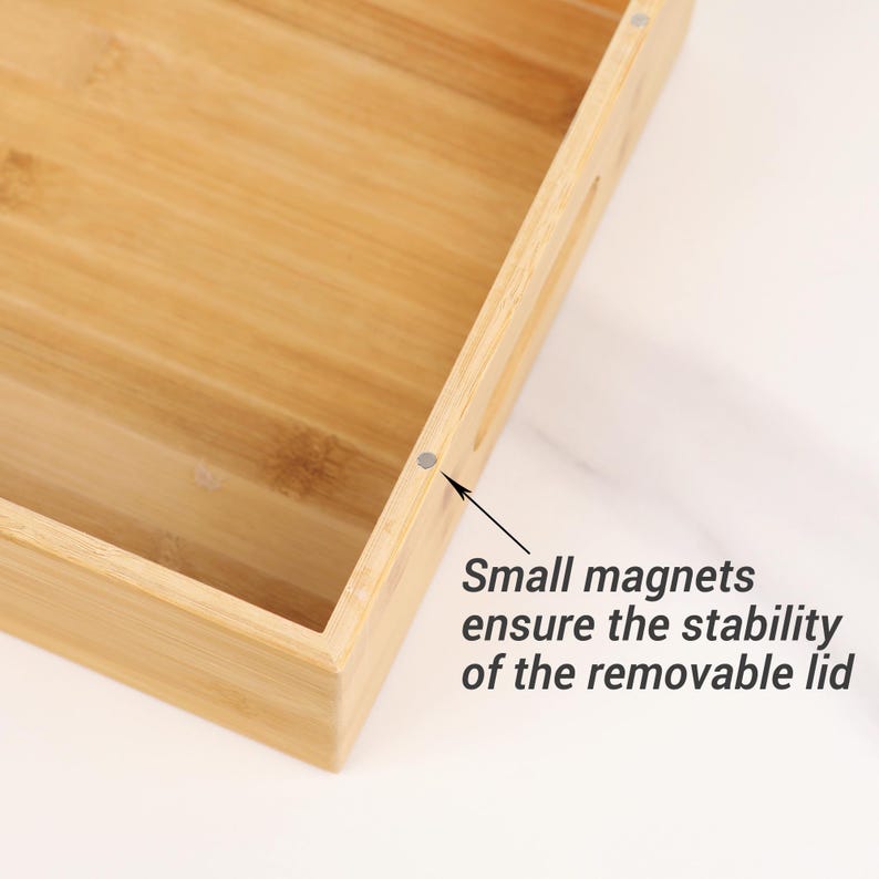May include: A rectangular bamboo tray with a light brown finish. The tray has a recessed interior and rounded corners. Small magnets ensure the stability of the removable lid.