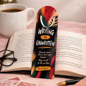 Puede incluir: Un marcapáginas rectangular vertical con la parte superior redondeada, con un diseño abstracto de pinceladas en rojo, naranja y negro. El texto dice: WRITING the UNWRITTEN, Because some stories don't just happen.. they wait to be writen, MisFit Writes.