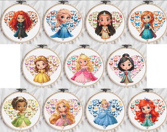May include: A collection of eleven cross-stitch embroidery hoops featuring cartoon princess designs. Each princess is centered within a heart-shaped arrangement of butterflies. The princesses wear colorful dresses and have unique hairstyles, set against a white fabric background.