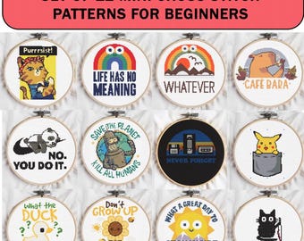 May include: A set of 12 mini cross stitch patterns for beginners. Each pattern is in a wooden hoop and features various designs, including a cat, panda, rainbow, and a sun. The text includes phrases like "Purrrsist!" and "Life Has No Meaning."