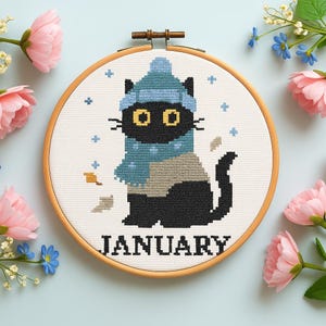 Cross stitch pattern set of 12 seasonal black cats, each in a unique monthly theme with flowers, costumes, or accessories. PDF digital download for embroidery lovers.