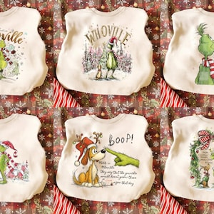 May include: Off-white Christmas-themed sweatshirts with various Grinch and Whoville designs. Each shirt features a different illustration, including the Grinch, a dog, and festive text. The shirts are displayed on a patterned background.