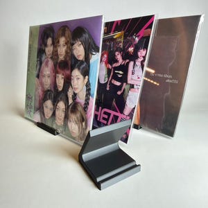 May include: A set of three ceramic mugs with a speckled, matte finish. The mugs are in shades of cream, light gray, and dark gray. Each mug has a simple, minimalist design, perfect for coffee or tea.