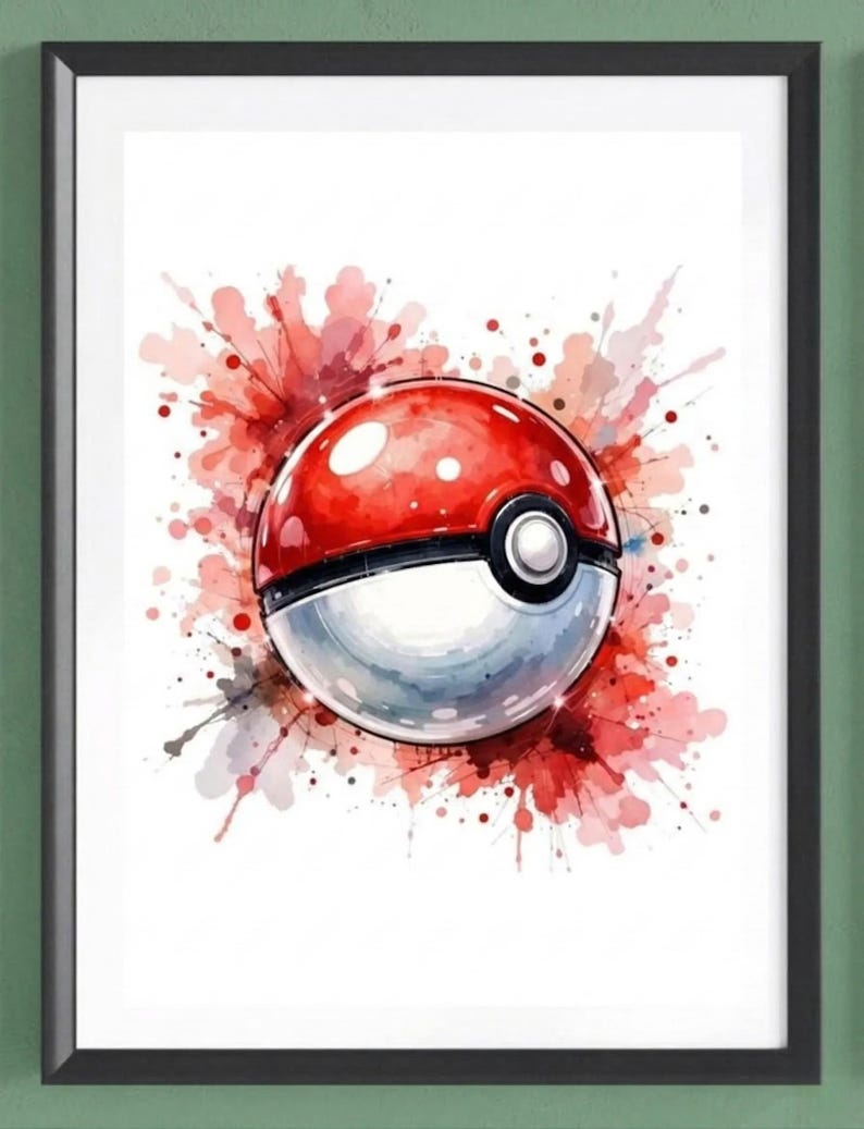 Op de afbeelding: Een ingelijste print met een aquarel-stijl illustratie van een rood-witte Pok&eacute; Ball. Het ontwerp bevat een spat van rode en roze aquarelverf, wat een dynamisch en artistiek effect cre&euml;ert. De print is ingelijst in een zwart frame.