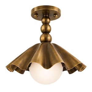 May include: A brass-toned ceiling light fixture with a decorative, ruffled shade and a spherical, frosted glass globe. The fixture has a round base and a series of stacked spheres connecting the base to the shade. The overall design is vintage-inspired.
