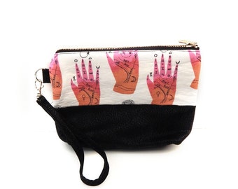 Palmistry Wristlet, Wristlet with Pink Palm design on white background with a black faux leather bottom and a detachable wrist strap