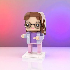 May include: A Lego-style figure of a person with brown hair, glasses, and a purple shirt. The figure is wearing a light blue and white plaid jacket and pink pants. The figure is standing on a white base against a gradient purple and pink background.