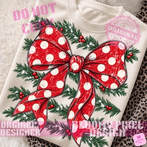 May include: A cream-colored crewneck sweatshirt featuring a large, distressed red bow with white polka dots. The bow is surrounded by green pine branches and small red berries, creating a festive holiday-themed graphic print on the front.