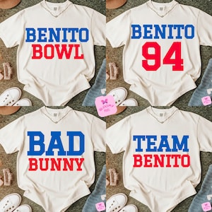 May include: Four cream-colored t-shirts with different text designs in blue and red. The designs include "BENITO BOWL", "BENITO 94", "BAD BUNNY", and "TEAM BENITO". The shirts are displayed with shoes and accessories.