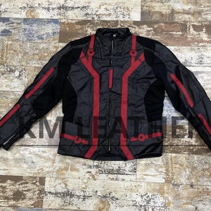 May include: Black and red motorcycle jacket with a full zipper closure. The jacket features red accent stripes and panels on the front, sleeves, and back. The jacket has a stand-up collar and a quilted design.