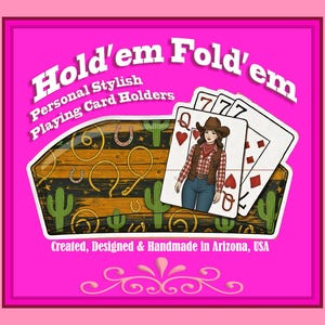 May include: A hot pink background features a playing card holder with the text "Hold'em Fold'em". The holder has a wooden design with cacti, horseshoes, and rope accents. Three playing cards are visible, including the Queen of Hearts and two sevens.