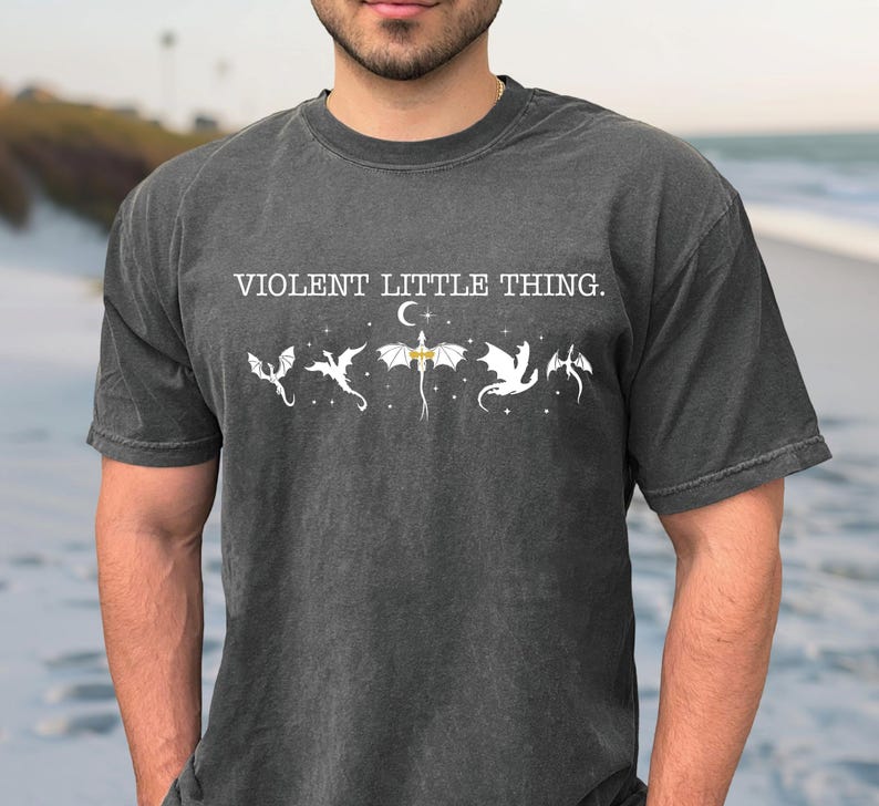 A man wearing a gray t-shirt with the text "VIOLENT LITTLE THING" printed on it.
