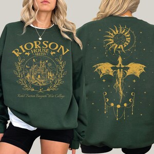a woman wearing a green harry potter sweatshirt
