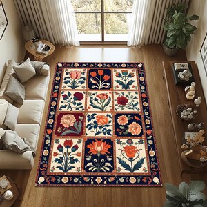 Könnte beinhalten: Ein rechteckiger Teppich mit floralem Muster. Der Teppich hat ein Raster aus quadratischen Feldern, die jeweils ein anderes Blumendesign in Rot-, Orange- und Cremetönen aufweisen, vor einem dunkelblauen Hintergrund. Der Teppich ist mit einem dunkelblauen und orangefarbenen Blumenmuster eingefasst.