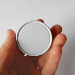 May include: A white round lid for a jar or container.