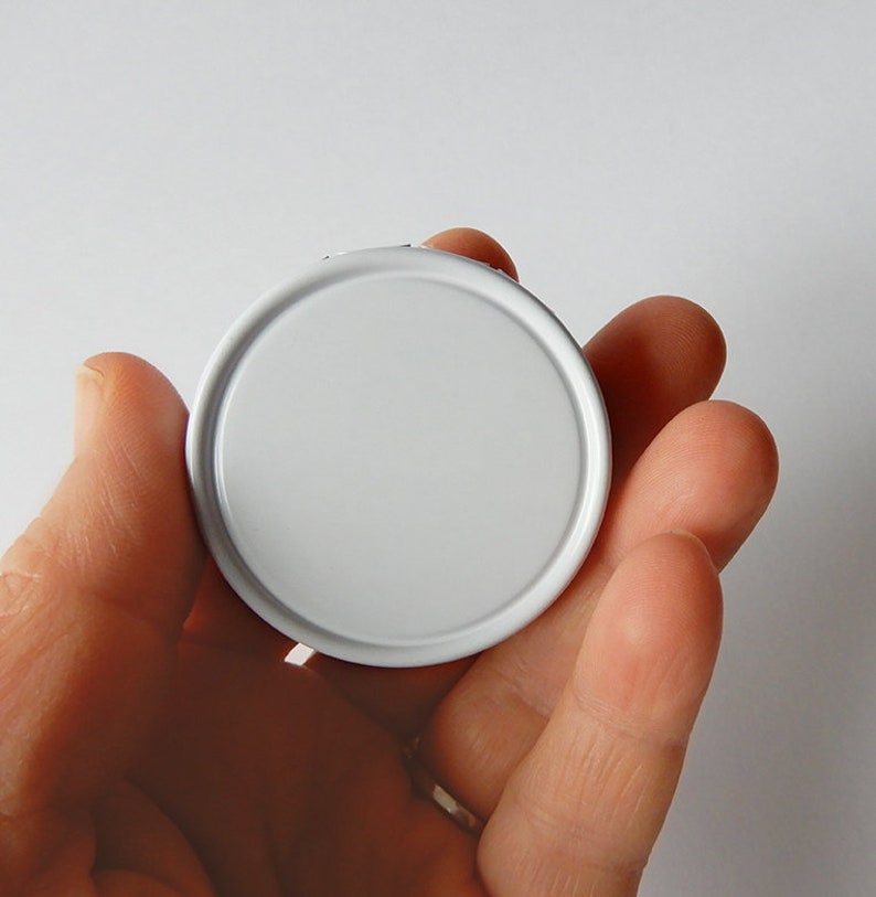 May include: A white round lid for a jar or container.