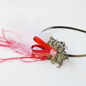 Metallic headband and red ostrich feathers white down festive hairstyle