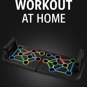 May include: Black push-up board with handles and color-coded positions for various exercises. The board has the text "FULL BODY WORKOUT AT HOME" in white. The board is designed for home fitness routines.