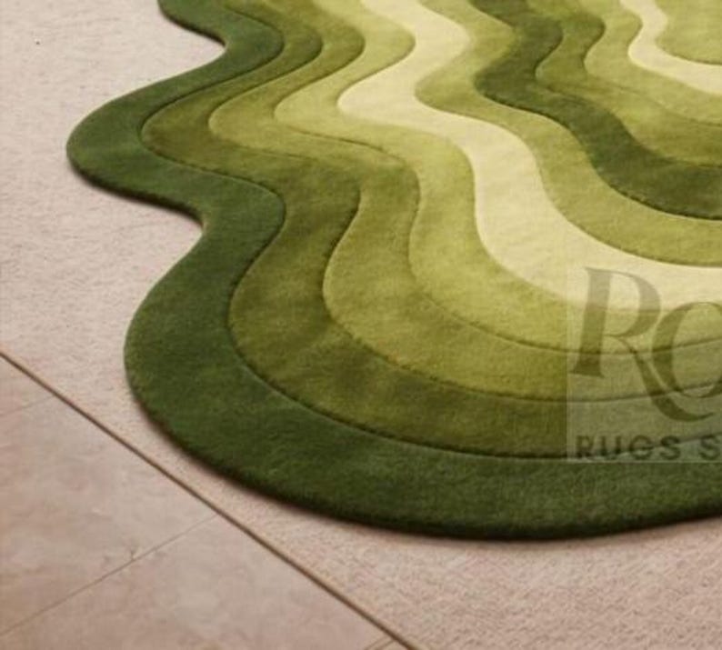 Topographic layered green area rug shown in a spacious classical interior. Wavy organic shape with multiple contour layers in deep and light green tones, resembling terrain elevation. Plush tufted texture, modern artistic floor decor for living rooms or luxury spaces.