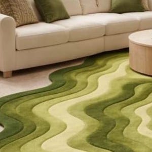 Topographic layered green area rug shown in a spacious classical interior. Wavy organic shape with multiple contour layers in deep and light green tones, resembling terrain elevation. Plush tufted texture, modern artistic floor decor for living rooms or luxury spaces.