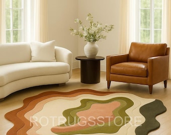 May include: A colorful, layered rug with a unique, organic shape. The rug features shades of brown, green, and pink, creating a warm and inviting aesthetic. The text "ROTRUGSSTORE" is visible on the rug.
