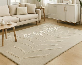 May include: Beige rectangular area rug with a raised leaf design. The rug is in a living room setting with a sofa, side tables, and a cabinet. The text "Rot Rugs Store" is printed on the rug.
