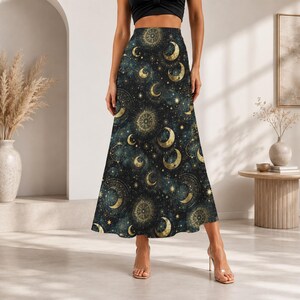 May include: A high-waisted maxi skirt featuring a dark navy blue background with a repeating celestial pattern of gold-coloured crescent moons, stars, and intricate circular astrological star charts across the entire fabric surface.