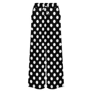Black wide-leg pants with large white polka dots and a drawstring waist are displayed. The design is bold and retro, conveying a playful tone.