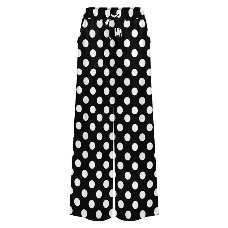 Black wide-leg pants with large white polka dots and a drawstring waist are displayed. The design is bold and retro, conveying a playful tone.