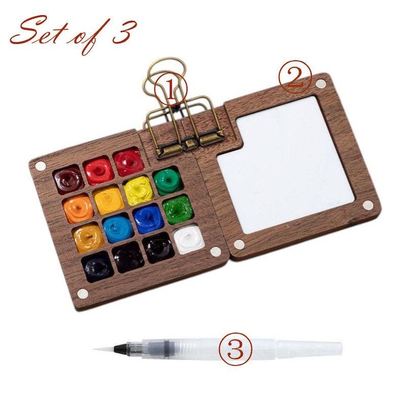 May include: A wooden watercolor paint set with a hinged lid, featuring a palette of vibrant colors and a built-in mixing area. Includes a water brush and is labeled "Set of 3". The set is designed for artists and hobbyists.