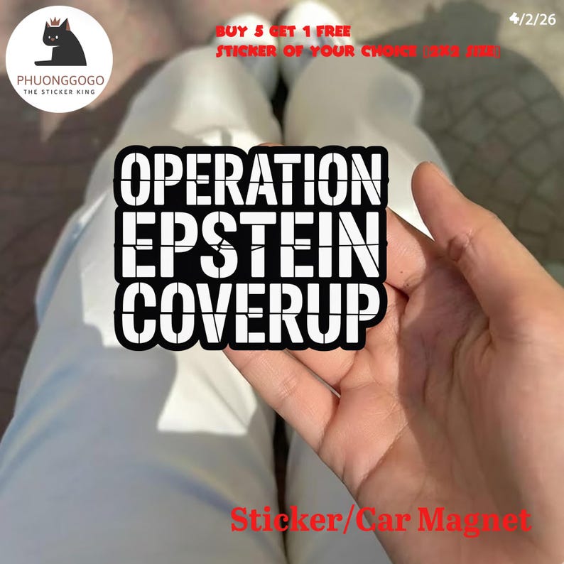 May include: A black and white sticker or car magnet with the text "OPERATION EPSTEIN COVERUP". The sticker is held in a person's hand. The sticker has a black border and white text. The sticker is from PHUONGGOGO, The Sticker King.