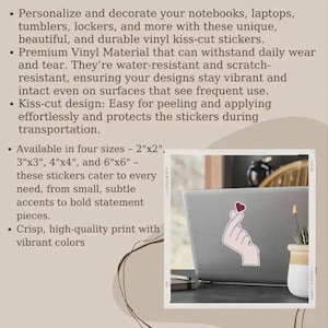 May include: A laptop displays a sticker with a hand gesture forming a heart. The image showcases vinyl kiss-cut stickers, available in various sizes, designed for personalizing items like notebooks and tumblers. The stickers are water-resistant and scratch-resistant.
