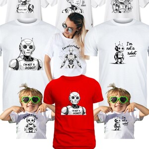 Puede incluir: Camisetas blancas y rojas con diseños de robots y el texto "I'm not a robot". La imagen incluye varias ilustraciones de robots y la frase "Trust me - I'm not a robot. Or am I?" en la parte inferior.