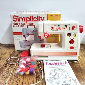 May include: A white Simplicity First Fashions LockStitcher sewing machine with red accents, a built-in ruler, and a power switch. Includes a box, a plastic bag of colorful thread spools, a red foot pedal, and a Lockstitch Sewing Machine instruction manual.