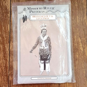 May include: A clear plastic package containing a sewing pattern. The pattern is for a breechclout and leggings, with the text "Missouri River Patterns" at the top. The image on the pattern shows a person in traditional Native American clothing.