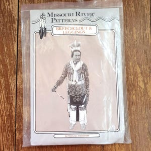 May include: A Missouri River Patterns sewing pattern packet for breechclout and leggings, pattern number 4799-500-006. The packaging features a black and white photograph of a person in traditional attire, enclosed in a clear plastic protective sleeve.
