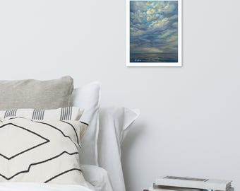 May include: A framed painting of a cloudy sky over a body of water. The artwork features shades of blue, gray, and yellow, with visible brushstrokes. The painting is signed in the lower left corner. The frame is white.