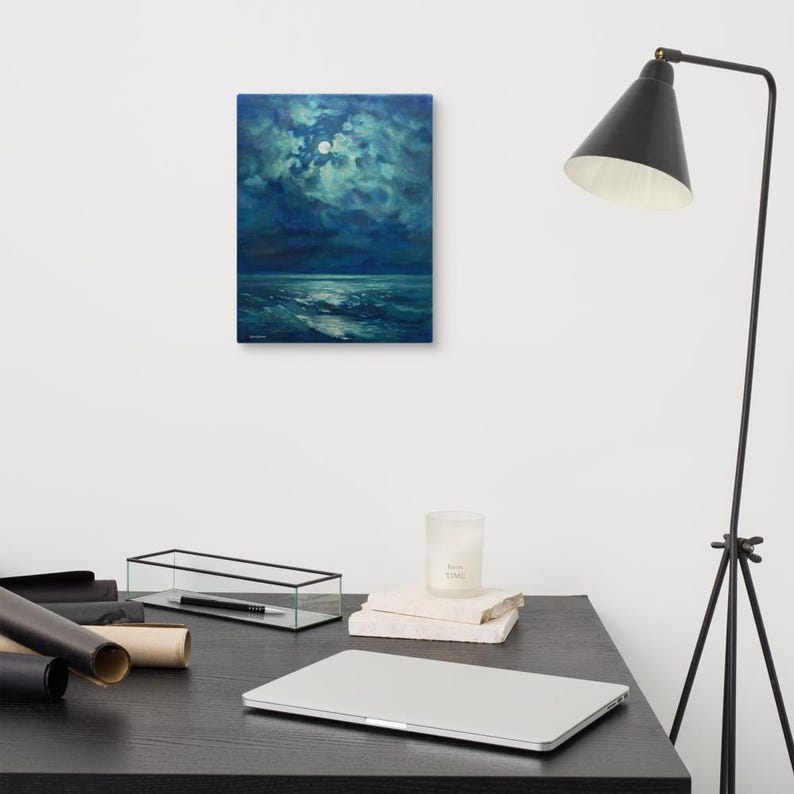 May include: An original oil painting depicting a moonlit seascape. The artwork features a dark blue sky with a full moon and clouds, reflecting on the ocean waves. The painting is displayed on a white wall.