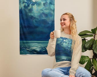 May include: A wall tapestry featuring a moonlit ocean scene with shades of blue and white. The artwork depicts a full moon in a cloudy sky above the ocean waves. The image is a vertical rectangle.